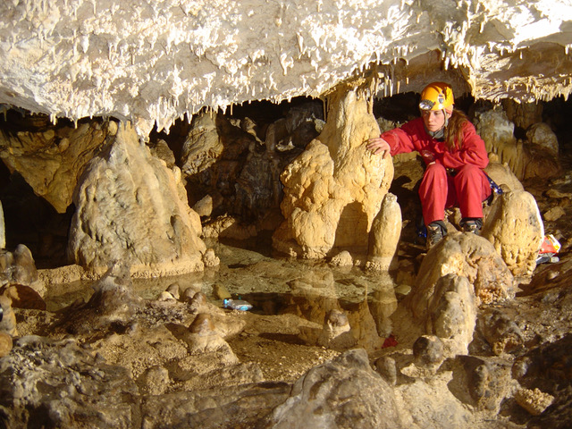 Cave explorer by underground ponds. Photo © Manu Guerrero Sanchez